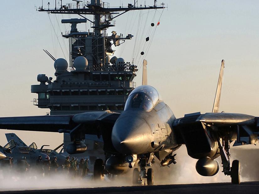 An F-14 fighter jet takes off from a Navy air craft carrier in the Persian Gulf