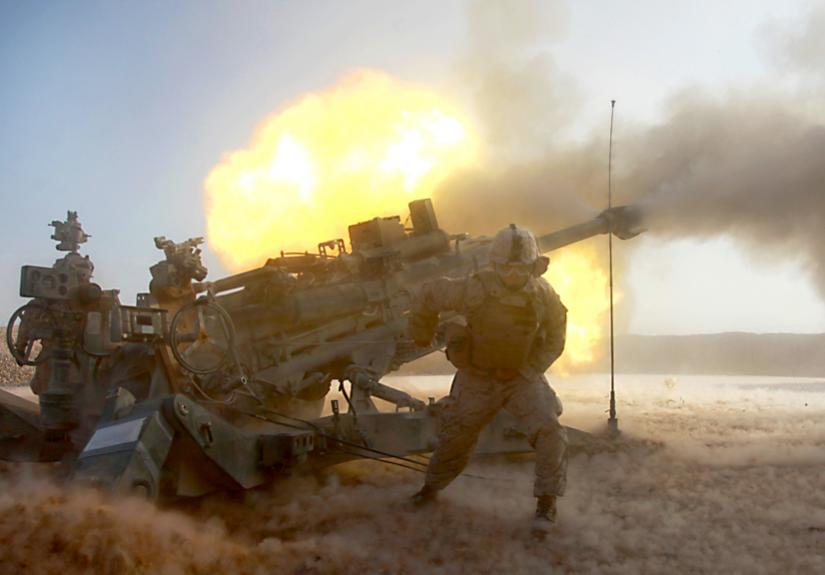Marines launch artillery fire during the assault on Marja
