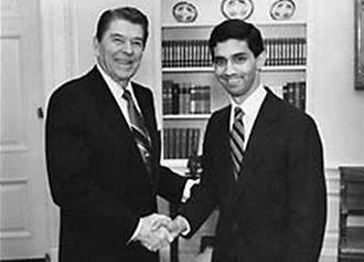 Dinesh D'Souza (to the right of Ronald Reagan) poses in the Oval Office