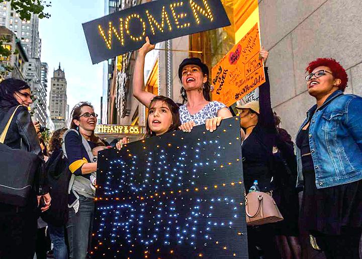 Women march in midtown Manhattan against Trump's sexism and bigotry