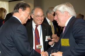 Former AIG CEO Martin J. Sullivan (left) hobnobs with the financial elite at an international banking seminar
