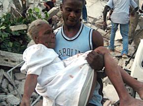 A man carries an injured woman from the rubble after the earthquake in Port-au-Prince