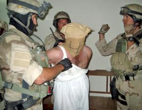 U.S. Navy Seals surround an Iraqi detainee