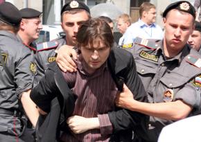 Russian police arrest an LGBT rights protester at a demonstration in May