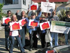 Larry Faulks (second from right) and anti-eviction activists rally outside his home