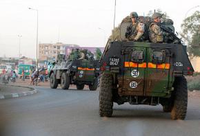 A convoy of French troops move through the streets of Bamako