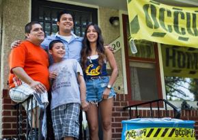 The Ceballos family stands in front of their occupied home in Minneapolis