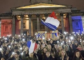 France's flag flies at a vigil in London in sympathy with the victims of the Paris attacks