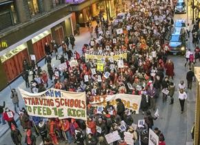 Chicago teachers on the march against threats and layoffs and a unilateral wage cut