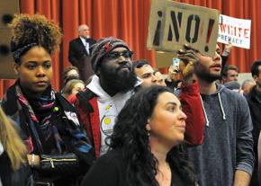 Students at Middlebury College stand up against racism during a lecture by Charles Murray