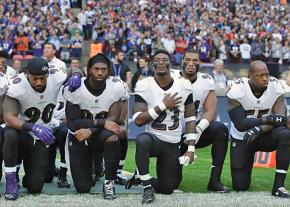 Members of the Baltimore Ravens kneel in protest during the National Anthem