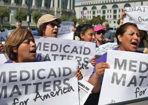 Protesters stand up against cuts in the Medicaid health program
