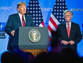 Donald Trump addresses the 2018 NATO summit alongside National Security Advisor John Bolton